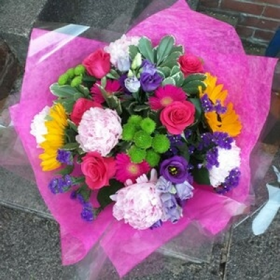 Bright and vibrant - Seasonal mix of bright and vibrant flowers presented in an aqua