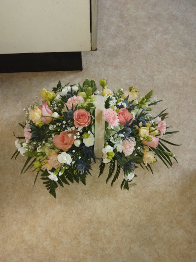Bon Bon - Shower them with love with this cutesy collection of seasonal flowers in pretty pastels. Beautifully arranged and stylishly presented in a traditional basket.