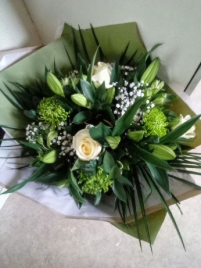 White Elegance - A White and green stunning elegant handtied arranged with lovely scented lilys and large headed white roses,

gyp and alstomeria not forgetting the green blooms awaiting to pop open

finished off with palm leaves Wrapped in green paper and white tissue finished off with a bow