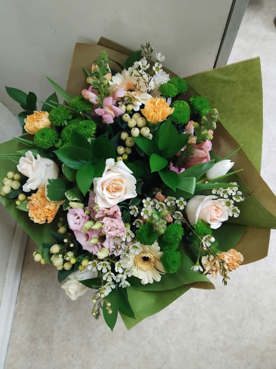 Peaches and creams - A mixture of  pastel colour flowers wrapped in kraft paper